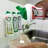 Handy Andy Cream Lavender 750ml being applied to a sponge in a kitchen setting, with product bottles in the background.