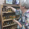 Ina Lessing Green Figs 410ml jar on a wooden shelf, showcasing fig preserves.
