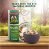 Jungle Muesli Tropical 750g pack with a bowl of muesli on a wooden surface, showcasing ingredients like oats, nuts, and dried fruits.