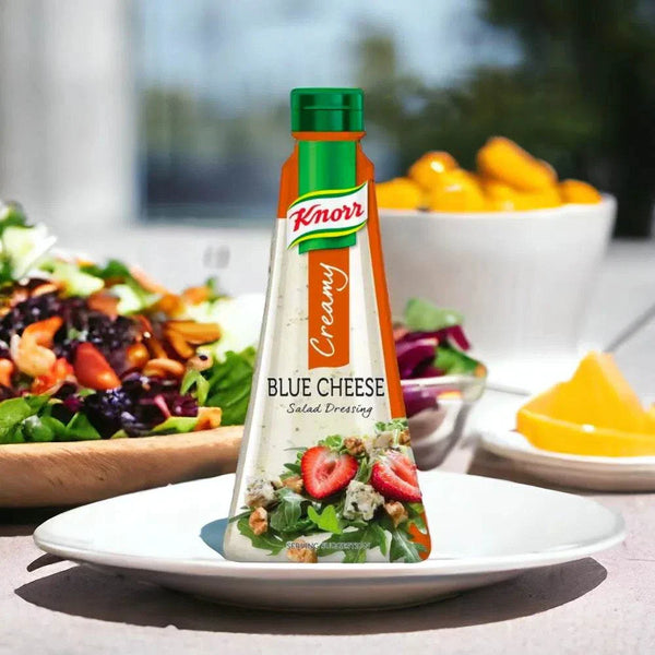 Knorr Creamy Blue Cheese Salad Dressing bottle on white plate with fresh salad background