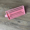 Pink medium-sized plastic Koeksister Cutter for slicing dough into traditional braided shapes