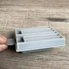 Small grey plastic Koeksister cutter for cutting traditional Afrikaans fried dough pastries