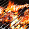 Grilled chicken drumsticks marinated with All Joy Marinade, sizzling on a barbecue.