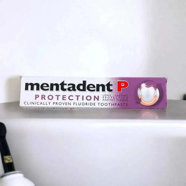 Mentadent P Toothpaste Protection 100ml box on a bathroom counter.