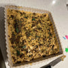 Peppermint Crisp Tart with chocolate and mint topping in square dish.