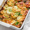 Delicious potato bake with parmesan, garlic, and herbs in a white baking dish.