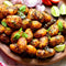 Ina Paarman Potato Spice with seasoned potatoes, garnished with herbs and limes.