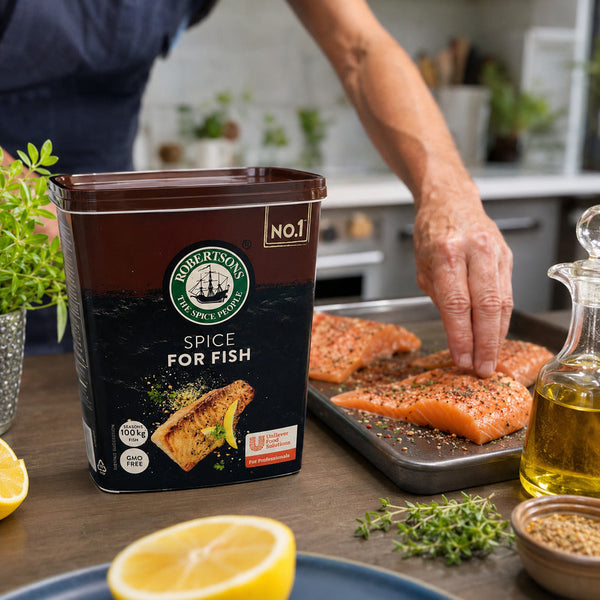 Robertsons Fish Spice 1kg beside seasoned salmon in a home kitchen