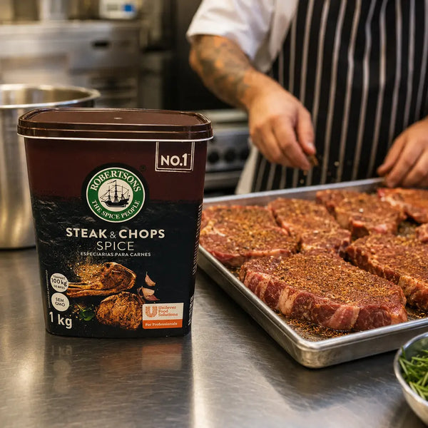 Robertsons Steak & Chops Spice 1kg in a professional kitchen with seasoned steaks