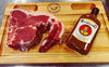 Rooibaard Original Sauce 250ml bottle next to raw steak on wooden board.