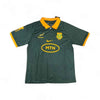 South African Rugby Supporter Jersey in dark green with orange collar and sleeve cuffs, featuring team logos and MTN sponsor, made with breathable DRI-FIT fabric, size X Large.