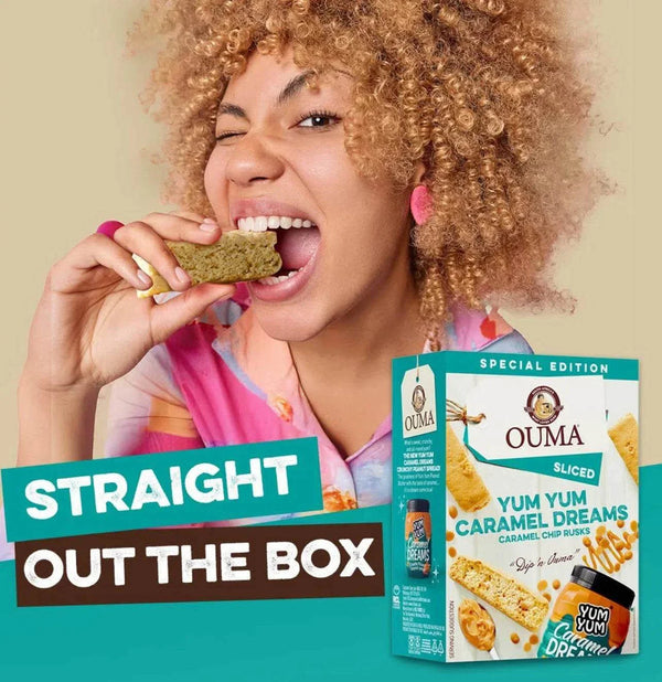 Ouma Rusks Yum Yum Caramel Dreams packaging with a woman enjoying a rusk straight from the box.