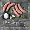 Natural sheep casings with raw sausages on slate board, surrounded by herbs, garlic, and salt.
