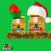 Black Cat Peanut Butter Smooth 400g jars with festive decorations on a green background.