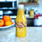 500ml Wimpy Mustard Sauce bottle on kitchen counter with oranges in the background.