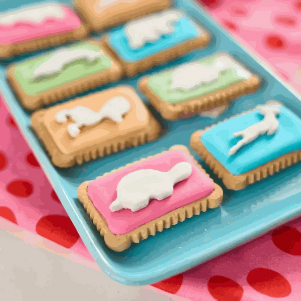 Pack of 12 Bakers Zoo Biscuits 150g with colorful iced animal shapes on vibrant backgrounds
