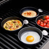 CADAC Tapas set of 4 pans on a grill with various foods.