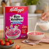 Kellogg's Strawberry Rice Krispies cereal with milk being poured into a breakfast bowl
