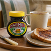 Marmite Yeast Extract 250g jar on a breakfast tray with toast and a hot drink