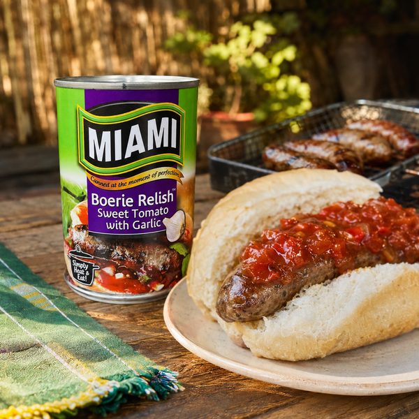 Miami Boerie Relish Sweet Tomato with Garlic 450g beside a boerewors roll