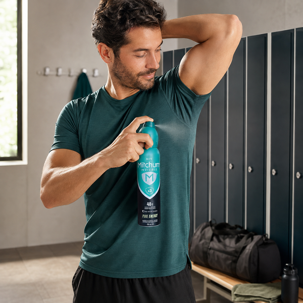 Man applying Mitchum Men Invisible Pure Energy 150ml at the gym