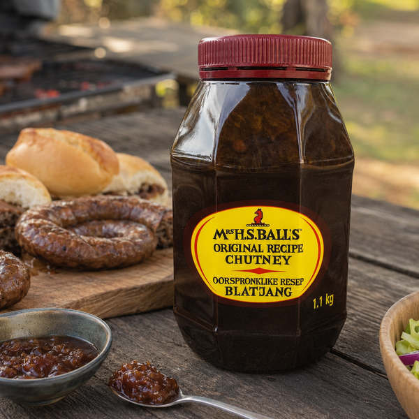Mrs H.S. Ball's Original Recipe Chutney 1.1kg jar at an outdoor boerewors braai